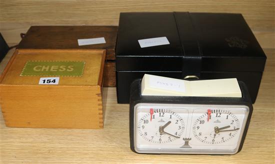 A weighted club-size chess set, two other boxed chess sets and a chess clock